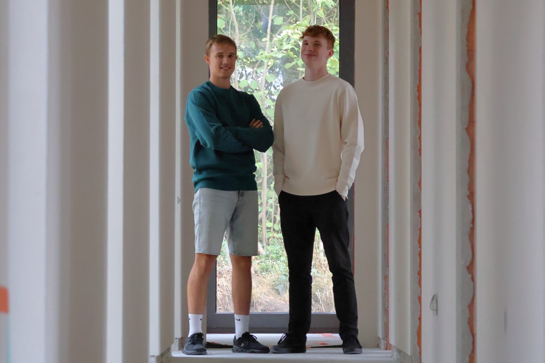 Honza and Matyáš, the founders of ARCHE, in a house under construction